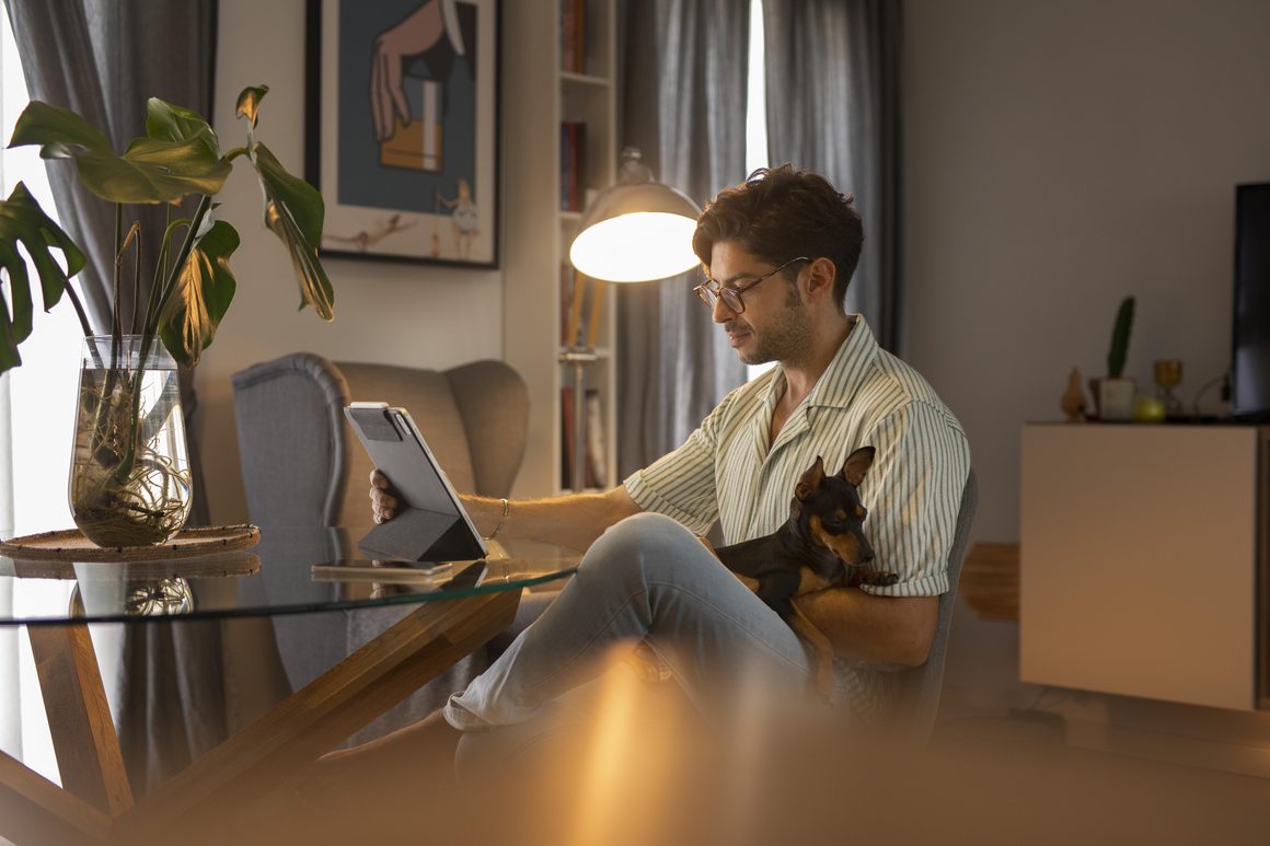 Newslikeyou.com Explores the Connection Between Technology, Work and Lifestyle 3 person working from home with pet dog